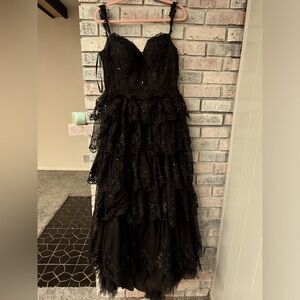 have a slit in the right leg. was altered to have a lace up back. JJs house.